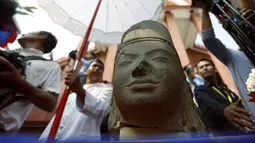 Kepala patung dewa Hindu dari abad ke-7 terlihat pada upacara di Museum Nasional Kamboja, di Phnom Penh, Kamis (21/1). Prancis mengembalikan kepala patung dewa yang disebut Harihara itu setelah diambil lebih dari 130 tahun lalu. (REUTERS/Samrang Pring)
