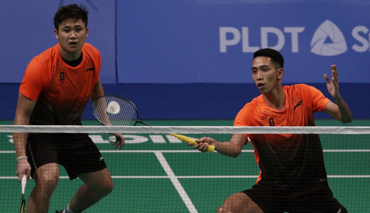 Ganda putra Indonesia, Wahyu Nayaka / Ade Yusuf, mengembalikan kok saat melawan Ong Yew Sin / Teo Ee Yi pada final beregu SEA Games 2019 di Multinlupa Sport Center, Rabu (4/12). Wahyu / Ade menang 21-15 dan 21-19. (Bola.com/M Iqbal Ichsan)