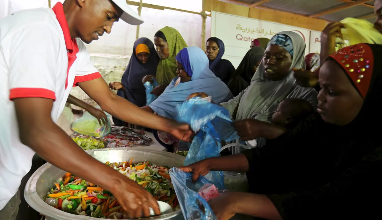Sejumlah wanita Somalia ketika mendapatkan iftar (makanan berbuka puasa) dari sebuah organisasi amal Qatar selama bulan suci Ramadan, di ibukota Mogadishu, Senin (22/6/2015). (REUTERS/Feisal Omar)
