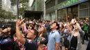 Warga menyaksikan aksi pendaki Prancis, Alain Robert memanjat Menara Internasional GT berlantai 47 di Makati City, Manila, Filipina (29/1). (AFP Photo/Ted Aljibe)