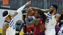 Pebasket Cleveland Cavaliers, Taurean Prince, berusaha melewati pebasket Minnesota Timberwolves, D'Angelo Russell dan Malik Beasley pada laga NBA di Rocket Mortgage FieldHouse, Senin (1/2/2021). Cavaliers menang dengan skor 100-98. (AP/Tony Dejak)