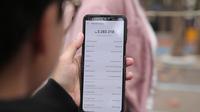 Seseorang menunjukkan sejumlah tagihannya di paylater salah satu di e-commerce. (Gempur M Surya/Liputan6.com)