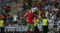 Bintang Portugal Cristiano Ronaldo bereaksi setelah pertandingan melawan Republik Irlandia pada babak kualifikasi Grup A Piala Dunia 2022 di Stadion Algarve, Kamis (2/9/2021) dini hari WIB. (CARLOS COSTA / AFP)