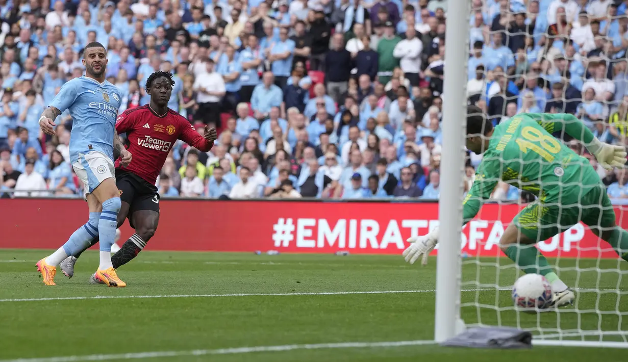 Gelandang Manchester United, Kobbie Mainoo (tengah) mencetak gol kedua timnya ke gawang Manchester City pada laga final Piala FA 2023/2024 di Wembley Stadium, London, Sabtu (25/5/2024). (AP Photo/Kin Cheung)