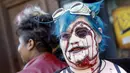 Seorang wanita mengenakan kostum monster untuk menyambut di Amerika, Minggu (18/10/2015). Perayaan Halloween dilakukan setiap bulan oktober. (REUTERS/Shannon Stapleton)