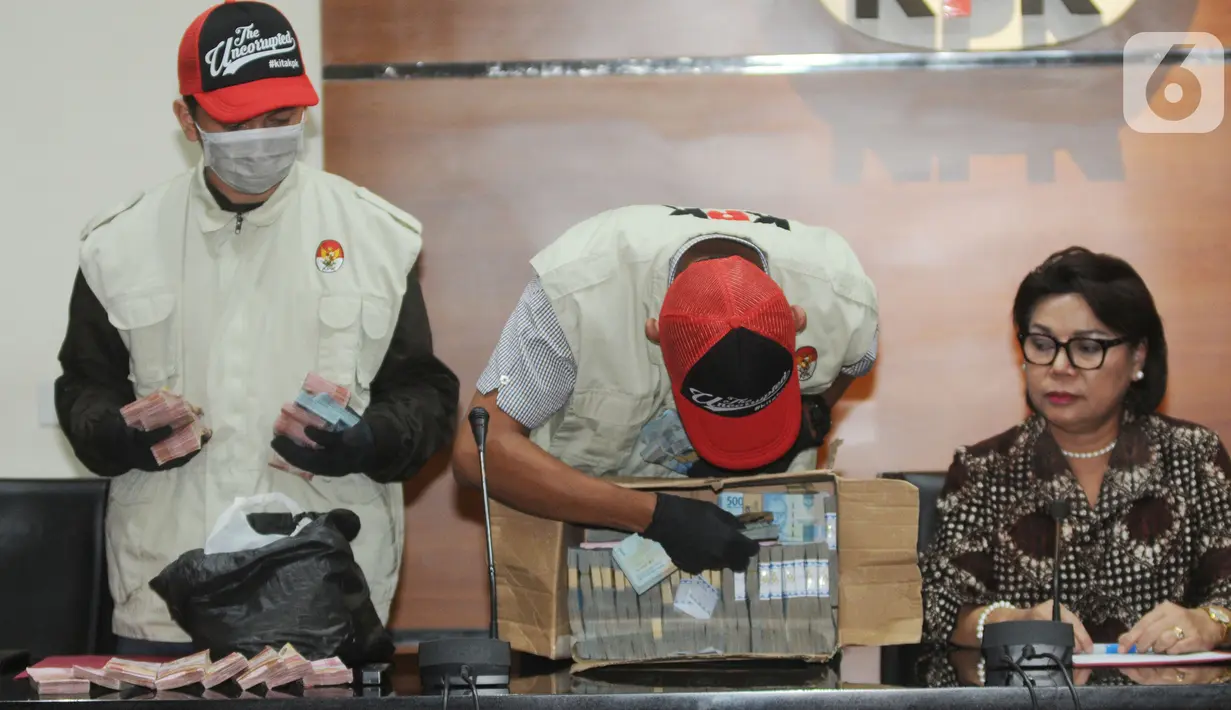 Petugas KPK menunjukkan barang bukti uang OTT Bupati Lampung Utara, Agung Ilmu Mangkunegara di Jakarta, Senin (7/10/2019) malam. KPK mengamankan barang bukti uang sekitar Rp728 juta dalam OTT terkait urusan proyek Dinas PUPR dan Dinas Perdagangan di Kabupaten Lampung Utara. (merdeka.com/Dwi Narwoko)