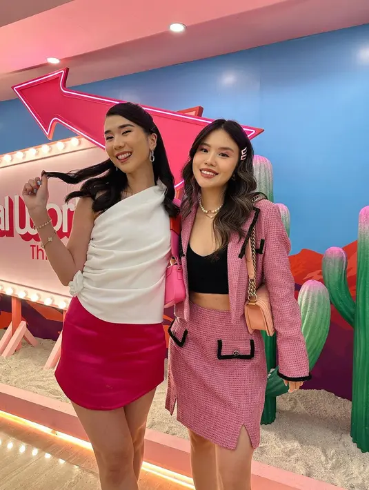 Christie terlihat manis dengan one shoulder top putih yang dipadu dengan rok mini warna fuschia. Begitu pula Titan Tyra dengan set tweed blazer warna pinknya. [Instagram/titantyra].