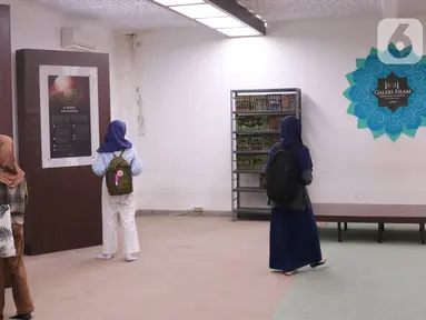 Pengunjung melihat sejumlah informasi tentang dunia Islam yang ada di galeri Islam masjid Al-Azhom, Tangerang, Banten, Jumat (22/4/2022). Banyak warga mengisi waktu senggang mengunjungi galeri tersebut untuk memperkaya wawasan tentang sejarah Islam saat Ramadhan. (Liputan6.com/Angga Yuniar)