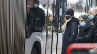 Orang-orang yang memakai masker menaiki bus di Brussels, Belgia, Rabu (17/11/2021). Pemerintah Belgia mewajibkan kembali penggunaan masker dan memberlakukan warga bekerja dari rumah dalam upaya untuk menahan lonjakan baru kasus COVID-19. (AP Photo/Olivier Matthys)