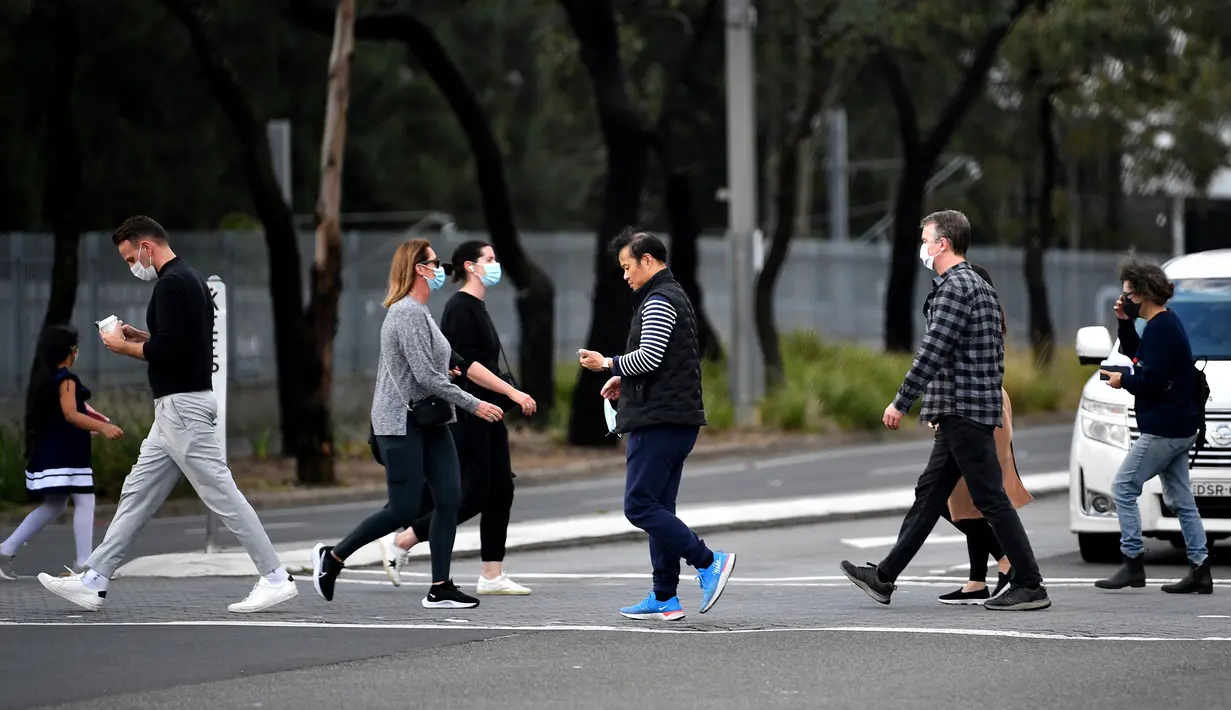 Warga Sydney berjalan menuju pusat vaksinasi Covid-19 di Sydney, Australia, Kamis (24/6/2021). Sebagian besar warga Sydney dilarang meninggalkan kota untuk menghentikan penyebaran virus corona Covid-19 varian Delta yang sangat menular ke wilayah lain. (SAEED KHAN / AFP)