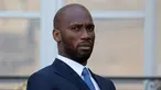 Didier Drogba saat tiba menghadiri undangan makan siang Presiden Liberia George Weah dan Presiden Prancis Emmanuel Macron di Istana Elysee di Paris, (21/2). Mantan penyerang Chelsea ini tampil dengan setelan jas berwarna biru. (AFP Photo/Ludovic Marin)