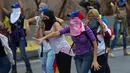 Sejumlah wanita ikut dalam aksi protes anti-pemerintah di Caracas, Venezuela, Kamis (13/4). Protes di Venezuela telah berlangsung sekitar satu bulan terakhir. (AP Photo / Ariana Cubillos)