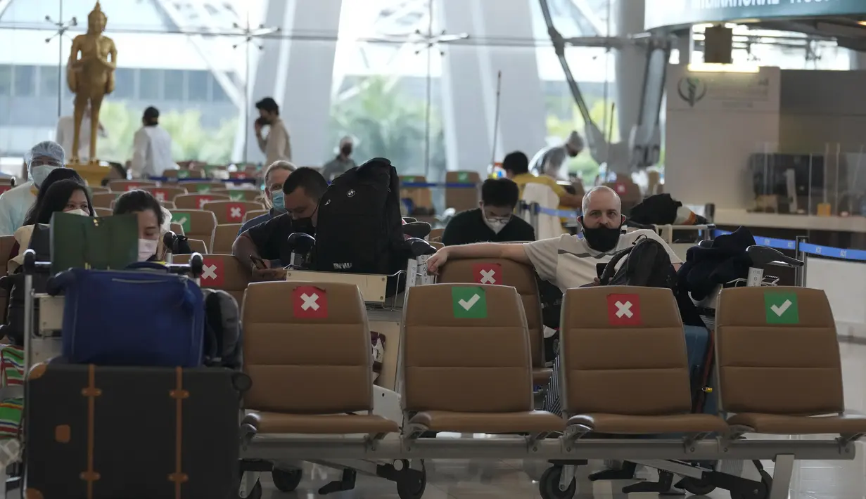 Turis dan staf hotel menunggu di Bandara Internasional Suvarnabhumi di Bangkok, Thailand, Senin (1/11/2021). Thailand mulai Senin ini telah dibuka kembali untuk wisatawan mancanegara yang divaksinasi penuh tanpa perlu menjalani proses karantina Covid-19. (AP Photo/Sakchai Lalit)