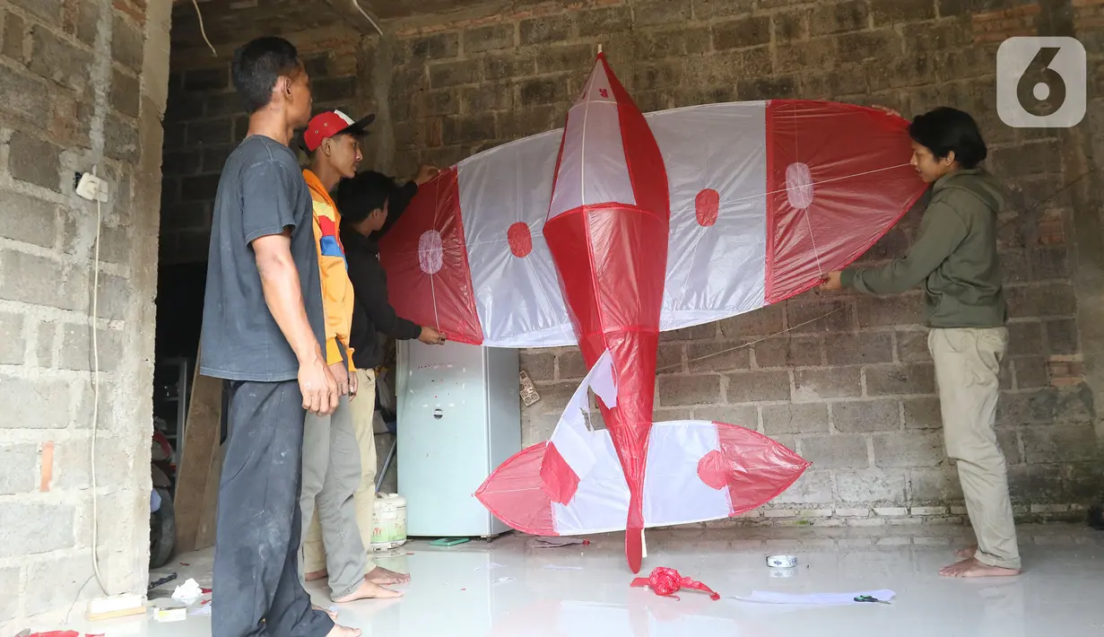 Anak – anak menyelesaikan pembuatan layangan di kawasan Gandaria, Depok, Jawa Barat, Selasa (30/06/2020). Ditengah pandemi COVID-19, anak - anak di kawasan Gandaria Depok mengisi waktu luang dengan membuat layang-layang dengan beragam bentuk. (Liputan6.com/Herman Zakharia)