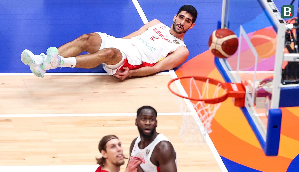 Pebasket Spanyol, Santiago Aldama melihat bola setelah melakukan three poin pada laga Grup L Piala Dunia FIBA 2023 melawan Kanada di Indonesia Arena, Senayan, Jakarta, Minggu (03/09/2023). Spanyol kalah dengan skor 85-88. (Bola.com/Bagasakara Lazuardi)