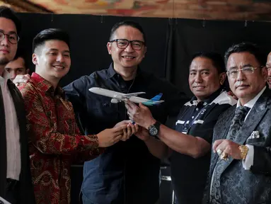 Dirut Garuda Indonesia I Gusti Ngurah Askhara Danadiputra (tiga kiri) bersama youtuber Rius Vernandes (kedua kiri) dan Ketua Harian Serikat Karyawan Garuda Indonesia Tomy Tampati (tiga kanan) foto bersama usai berdamai di Jakarta, Jumat (19/7/2019). (Liputan6.com/Faizal Fanani)