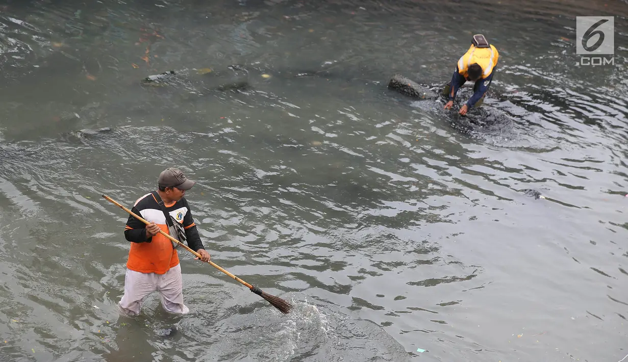 Petugas membersihkan sampah yang mengotori Kali Cideng, Jakarta, Minggu (23/7). Kurangnya kesadaran warga akan kebersihan membuat kali di Ibu Kota banyak dipenuhi sampah, terutama limbah rumah tangga. (Liputan6.com/Immanuel Antonius)