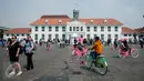 Warga berwisata menaiki sepeda kuno di kawasan Kota Tua, Jakarta, Senin (5/1). Meskipun libur panjang akan berakhir, warga tetap memadati kawasan wisata Kota Tua. (Liputan6.com/Gempur M Surya)
