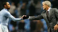 Manchester City's striker Robinho shakes hands with manager Mark Hughes after winning their Premier League football match against Newcastle at the City Of Manchester Stadium in Manchester on January 28, 2009. AFP PHOTO/Glyn Kirk
