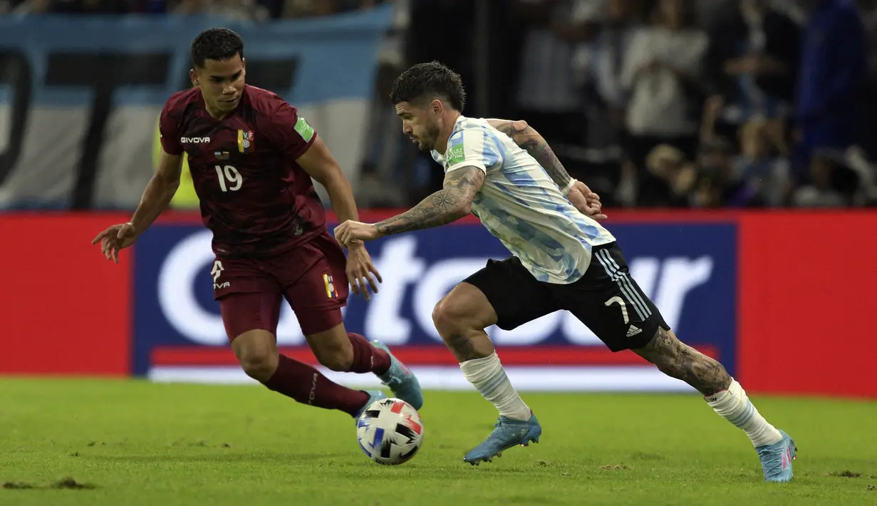 Pemain Venezuela Miguel Navarro (kiri) dan pemain Argentina Rodrigo De Paul memperebutkan bola pada pertandingan sepak bola kualifikasi Piala Dunia 2022 di Stadion La Bombonera, Buenos Aires, Argentina, 25 Maret 2022. Argentina menang 3-0. (Juan Mabromata/AFP)