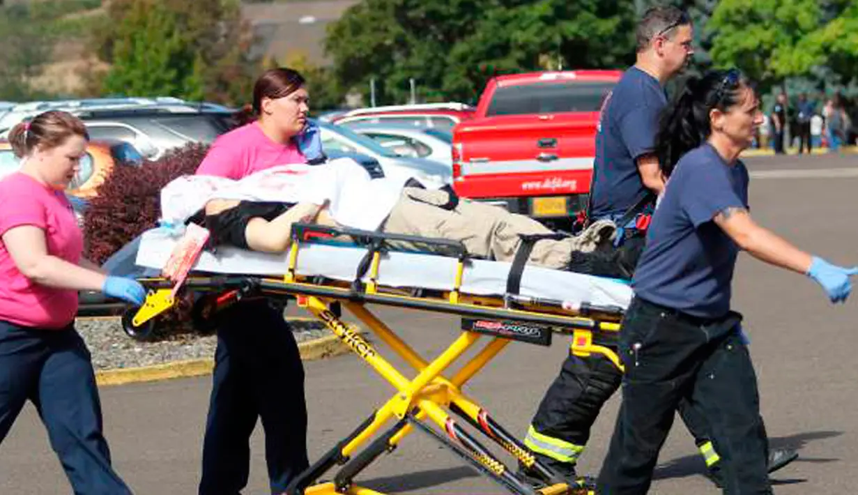 Petugas mengevakuasi korban terluka setelah penembakan yang terjadi di Umpqua Community College di Roseburg, Oregon, AS, Kamis (1/10/2015). 13 orang tewas dan sekitar 20 lainnya terluka akibat kejadian tersebut. (REUTERS/Michael Sullivan/The News-Review)
