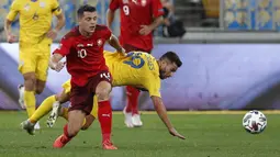 Gelandang Swiss, Granit Xhaka, berebut bola dengan penyerang Ukraina, Junior Moraes, pada laga Nations League di Stadion Arena Lviv, Jumat (4/9/2020) dini hari WIB. Ukraina menang 2-1 atas Swiss. (AFP/Anatolii Stepanov)