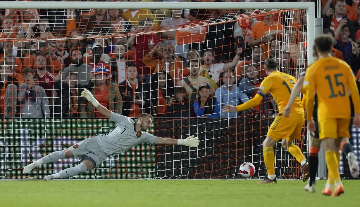 Penjaga gawang Belanda Jasper Cillessen gagal menghentikan penalti pemain Wales Gareth Bale (11) pada pertandingan sepak bola UEFA Nations League di Stadion De Kuip, Rotterdam, Belanda, 14 Juni , 2022. Belanda menang dengan skor 3-2. (AP Photo/Peter Dejong)