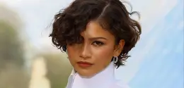 Zendaya melangkah ke show Louis Vuitton dengan potongan curly micro bob yang segar dan edgy.  [@zendayacit/@lesfacons].