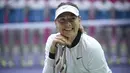 Senyum Maria Sharapova saat berpose dengan trofi setelah memenangkan pertandingan melawan Aryna Sabalenka di turnamen tenis Tianjin Open di Tianjin (15/10). Sharapova menang 7-5 7-6 atas Sabalenka. (AFP Photo/Wang Zhao)