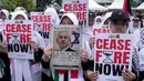 Berbagai komunitas internasional dari 50 negara lebih secara serentak menggelar Hari Aksi Global untuk Gaza dengan melakukan demonstrasi di jalan-jalan di seluruh dunia. (AP Photo/Dita Alangkara)