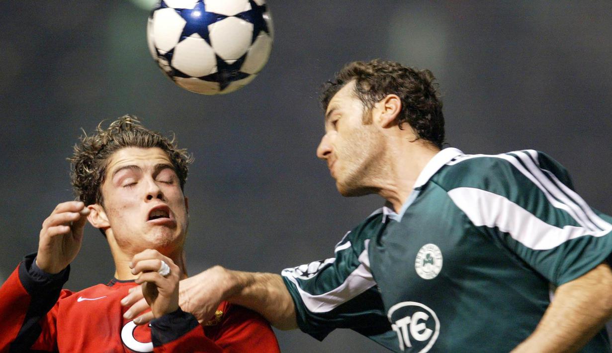 Gelandang Manchester United, Cristiano Ronaldo, duel udara dengan bek Panthinaikos, Ioannis Goumas, pada laga Liga Champions di Athena, Yunani, Rabu (23/11/2003). (AFP/Aris Messinis)