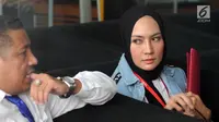 Model Fenny Steffy Burase (kanan) bersiap menjalani pemeriksaan di Gedung KPK, Jakarta, Rabu (1/8). Steffy diperiksa sebagai saksi untuk tersangka Gubenur Aceh Irwandi Yusuf. (Merdeka.com/Dwi Narwoko)