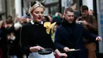 Seorang peserta ikut ambil bagian dalam acara tahunan Great Spitalfields Pancake Race untuk mengumpulkan uang bagi Ambulan Udara London di Inggris, Selasa (9/2). (REUTERS/Stefan Wermuth)