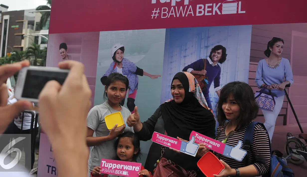 Pengunjung foto bersama usai mendapatkan Tupperware, Jakarta (12/4).2500 Tupperware dibagikan secara gratis sebagai dukungan untuk membangun pola hidup sehat, hemat, dan ramah lingkungan melalui kebiasaan membawa bekal. (Liputan6.com/Gempur M Surya)