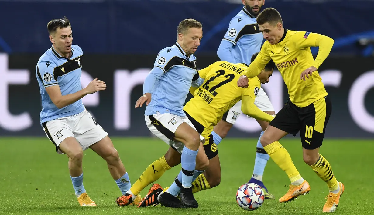 Gelandang Borussia Dortmund, Thorgan Hazard berebut bola dengan gelandang Lazio, Lucas Leiva pada matchday kelima Grup F Liga Champions di Signal Iduna Park, Dortmund, Kamis (3/12/2020) dinihari WIB. Borussia Dortmund cuma berimbang 1-1 dengan Lazio. (AP Photo/Martin Meissner, Pool)