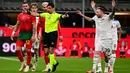 Wasit Gianluca Manganiello (tengah) memberi isyarat di samping bek AC Milan Kyle Walker (kiri) dan gelandang Lazio Manuel Lazzari saat pertandingan ke- 27 Serie A Italia 2024/2025 di stadion San Siro, Milan, pada Minggu 2 Maret 2025 waktu setempat atau Senin (3/3/2025) dini hari WIB. (Piero CRUCIATTI/AFP)