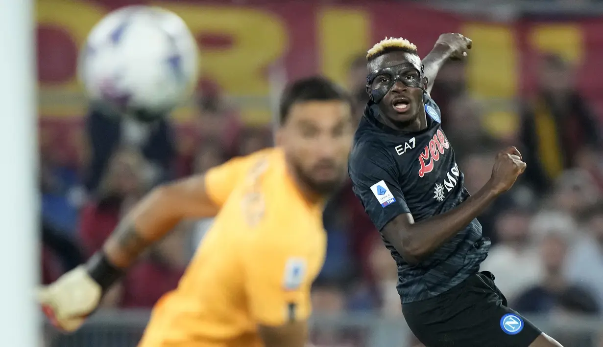 Pemain Napoli, Victor Osimhen (kanan) mencetak gol pembuka timnya saat laga pekan ke-11 Liga Italia 2022/2023 antara AS Roma melawan Napoli, di stadion Olimpic, Minggu (23/10/2022). (AP/Andrew Medichini)