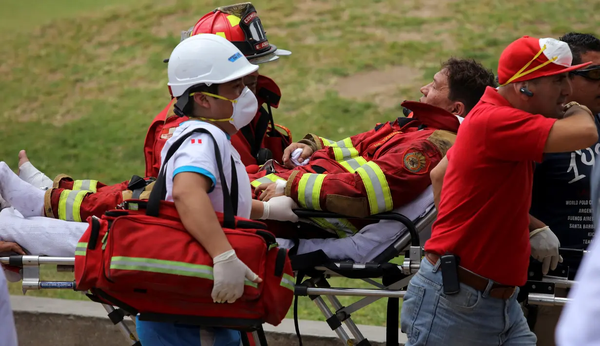 Seorang petugas pemadam yang terluka dievakuasi dari Mal Larcomar di pusat Ibu Kota Peru, Lima, Rabu (16/11). Petugas pemadam mengatakan api mulai muncul di bioskop pada salah satu lantai terendah mal. (REUTERS/Guadalupe Pardo)