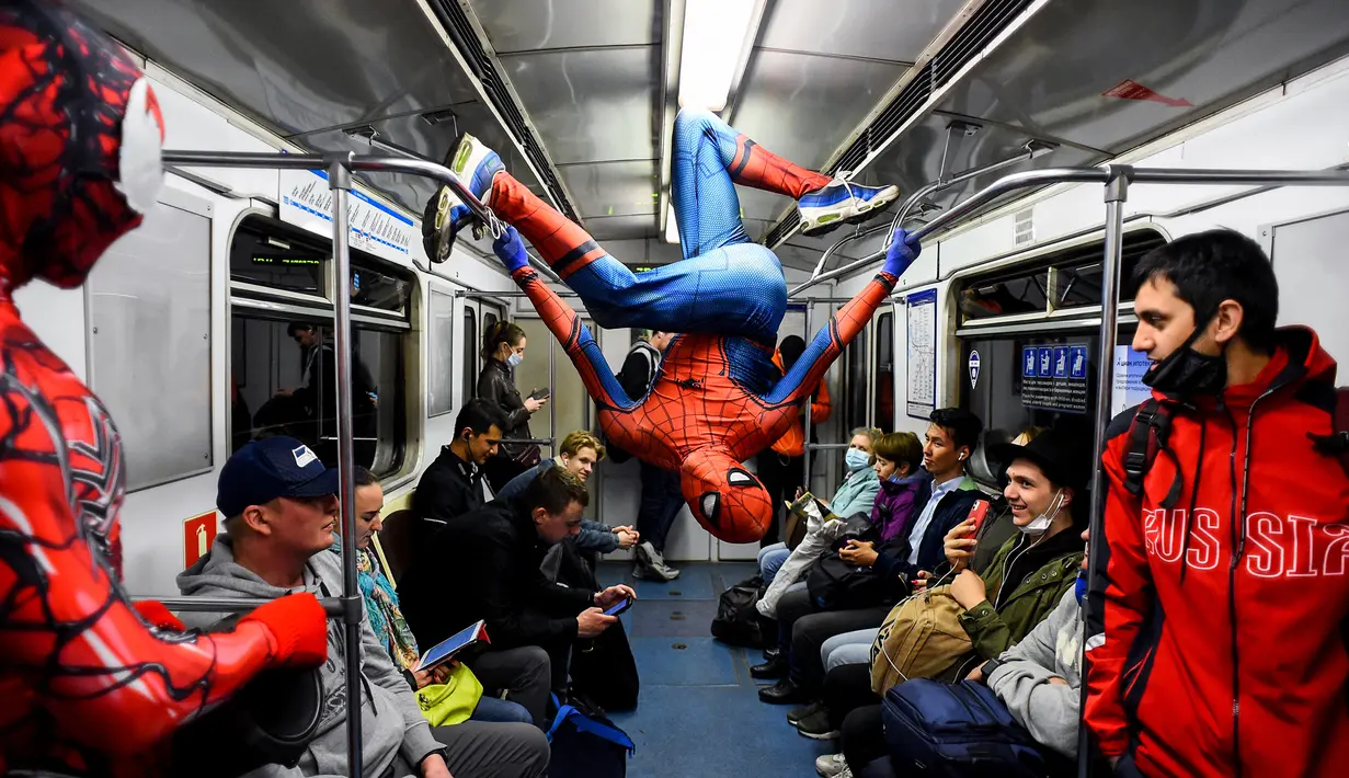 Penari underground yang mengenakan kostum Spiderman tampil di kereta bawah tanah Saint Petersburg, Rusia pada 21 Mei 2021. Kemunculan dua penari berkostum Spiderman tersebut membuat sejumlah penumpang yang berada di dalam subway kaget dan terhibur. (Olga MALTSEVA / AFP)