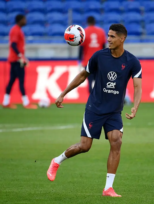 Bek Prancis, Raphael Varane mengontrol bola selama sesi latihan di Stadion Groupama di Decines-Charpieu dekat Lyon, Senin (6/9/2021). Prancis akan berhadapan dengan Finlandia dalam lanjutan Kualifikasi Piala Dunia 2022 zona Eropa Grup D, Rabu (8/9) dinihari. (FRANCK FIFE / AFP)