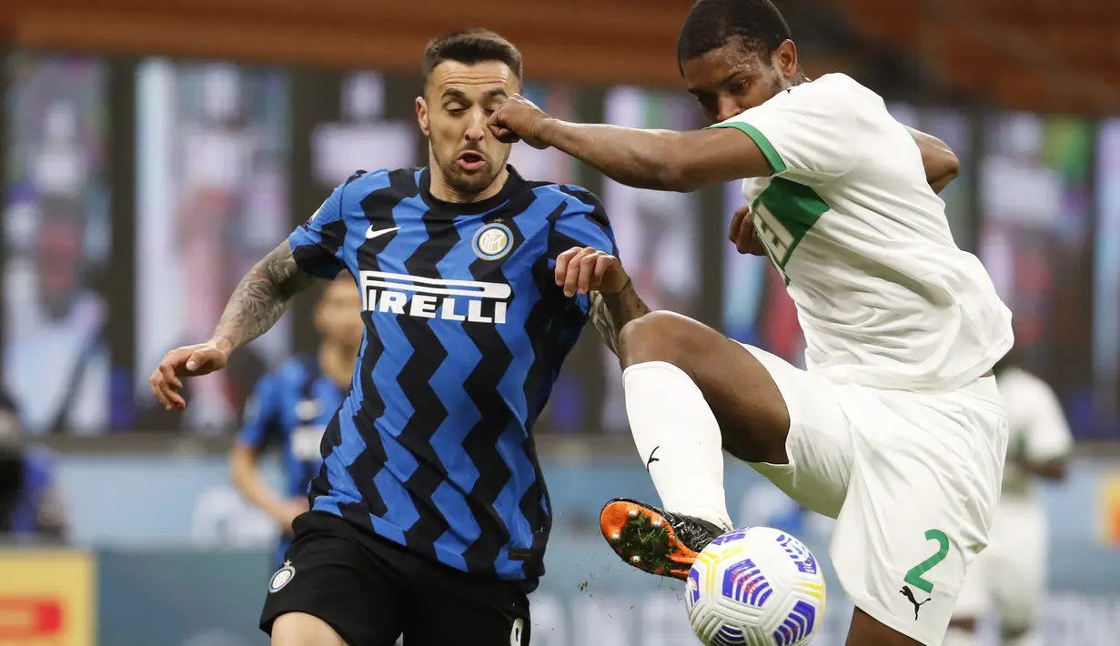 Gelandang Inter Milan, Matias Vecino berebut bola dengan bek Sassuolo, Marlon pada laga tunda Liga Italia di Stadio Giuseppe Meazza, Kamis (8/4/2021) dini hari WIB. Bermain di kandang, Inter Milan mengalahkan Sassuolo dengan skor 2-1. (AP Photo/Antonio Calanni)