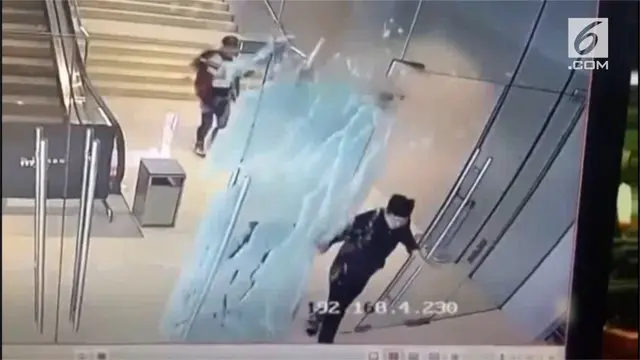 Rekaman kamera pengawas saat pengunjung pusat perbelanjaan menabrak pintu kaca hingga pecah.
