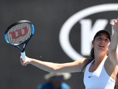 Aksi petenis cantik asal Prancis, Oceane Dodin saat melakukan serveis melawan petenis Kanada, Eugenie Bouchard pada putaran pertama Australia Tebuka di Melbourne, (16/1/2018). (AFP/Saeed Khan)