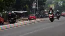 Pengendara melintasi Jalan TB Simatupang, Jakarta, Jumat (7/7). Jalan TB Simatupang sekitar perempatan Pasar Rebo menjadi berwarna dengan tampilan pot cat dan pembatas jalan warna warni. (Liputan6.com/Helmi Fithriansyah)