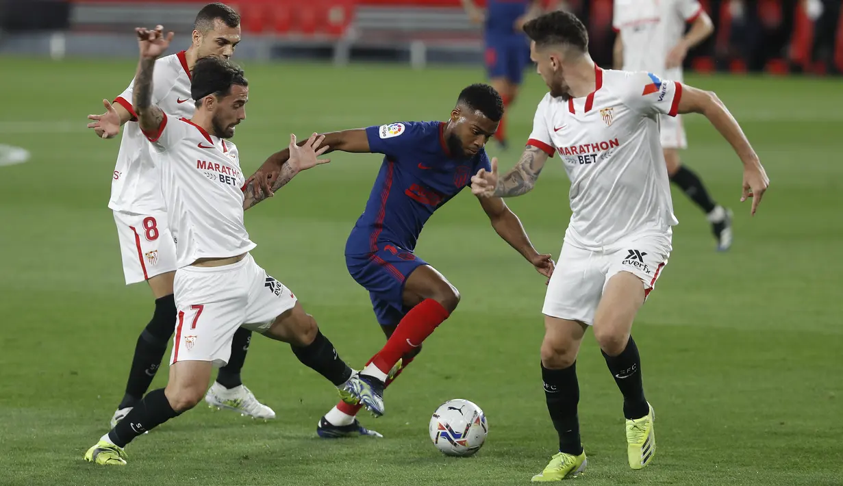 Bek Atletico Madrid, Renan Lodi bersaing memperebutkan bola gelandang Sevilla, Suso pada pekan ke-29 Liga Spanyol di Wanda Metropolitano, Madrid, Senin (5/4/2021) dini hari WIB. Tandang ke markas Sevilla, Atletico Madrid kalah dengan skor 0-1. (AP Photo/Angel Fernandez)