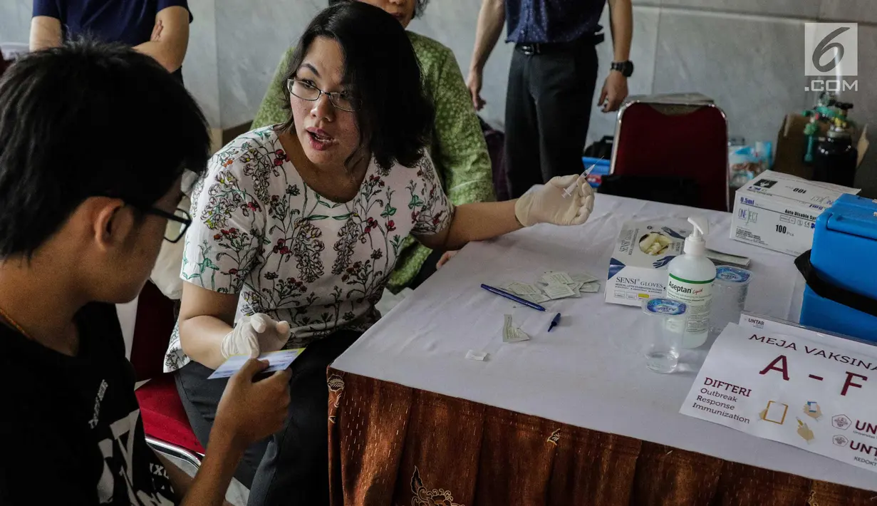 Mahasiswa bersiap disuntik vaksin difteri di Universitas Tarumanegara, Jakarta, Kamis (14/5). Ratusan mahasiswa/wi yang berusia di bawah 19 tahun mendapatkan imunisasi (Td) sebagai antisipasi mewabahnya penyakit difteri. (Liputan6.com/Faizal Fanani)