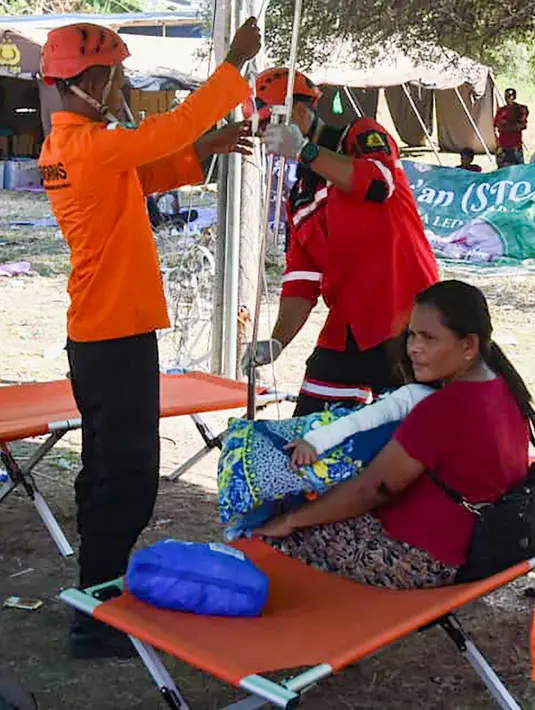 Sorang pasien korban gempa NTT mendapatkan perawatan sembari menunggu evakuasi menggunakan helikopter di Lamba Leda Utara, Nusa Tenggara Timur, Selasa, 18 Agustus 2026. (Basarnas)