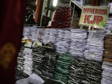 Salah satu penjual seragam sekolah di kawasan Pasar Jatinegara, Jakarta, Selasa (30/6/2020). Sejumlah pedagang di tempat itu mengeluhkan omset penjualan seragam sekolah yang menurun hingga 90 persen akibat sepi pembeli dan anjuran belajar di rumah saat pandemi COVID-19. (Liputan6.com/Faizal Fanani)