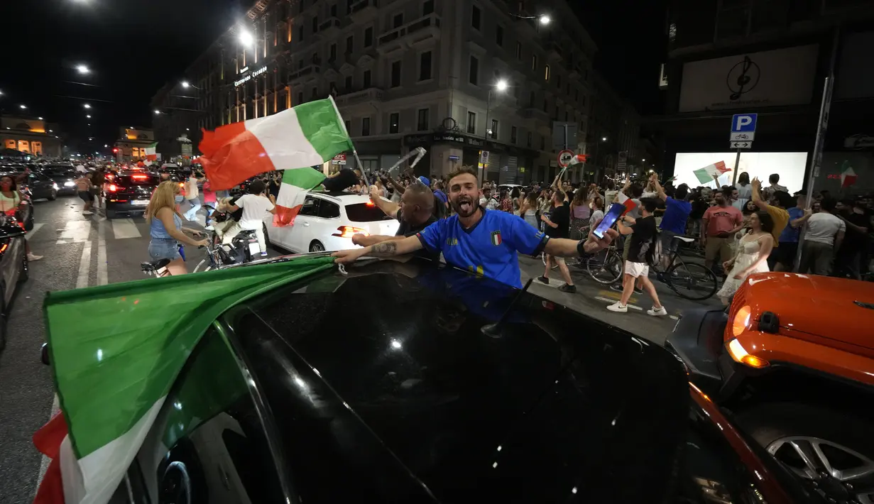 Suporter merayakan kemenangan Italia atas Inggris pada pertandingan final Euro 2020 di Milan, Italia, Senin (12/7/2021). Italia menjuarai Euro 2020 usai mengalahkan Inggris lewat drama adu penalti pada pertandingan final. (AP Photo/Luca Bruno)