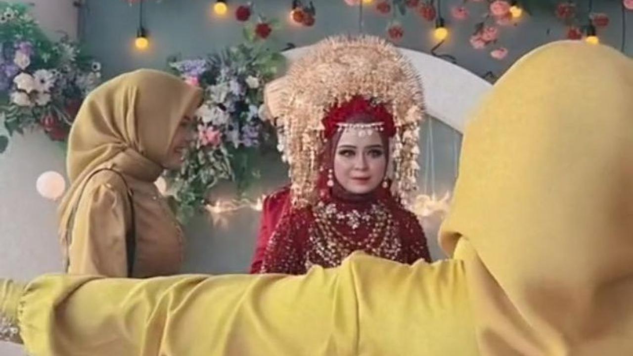 Setelah sampai di pelaminan, kedua sahabat yang menutupinya pun menyingkir. Wanita ini langsung membuka tisu dan langsung membuka tangannya agar dipeluk oleh sahabatnya.